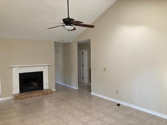 Family room showing wood burning fireplace with mantle