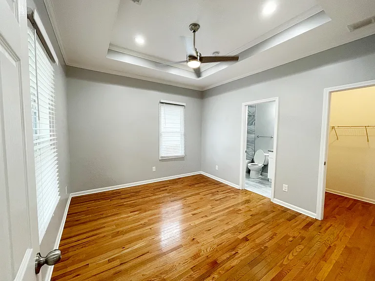 Master bedroom with en suite bathroom and walk-in closet