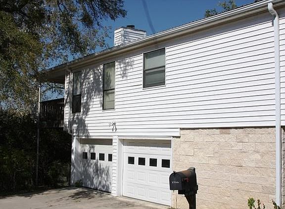 Two car garage.  Holds full size pickup and suburban.  Stone wall to right of garage is utility area and full bath.