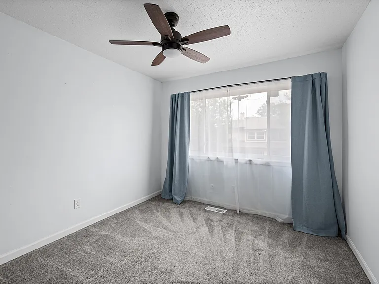 Bedroom 2 with ceiling fan and reach in closet