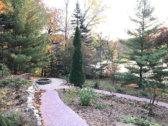 Stone patio with seating overlooking lake