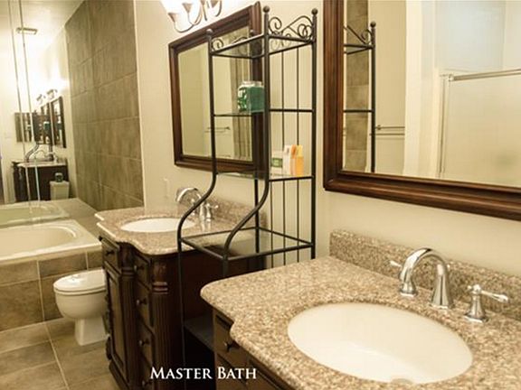 Double sink and granite countertops in master bath.