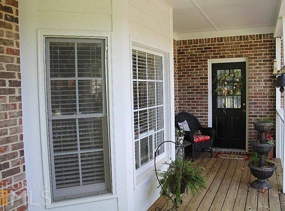Big bay windows let in lots of light! Front porch has side entry to mudroom.