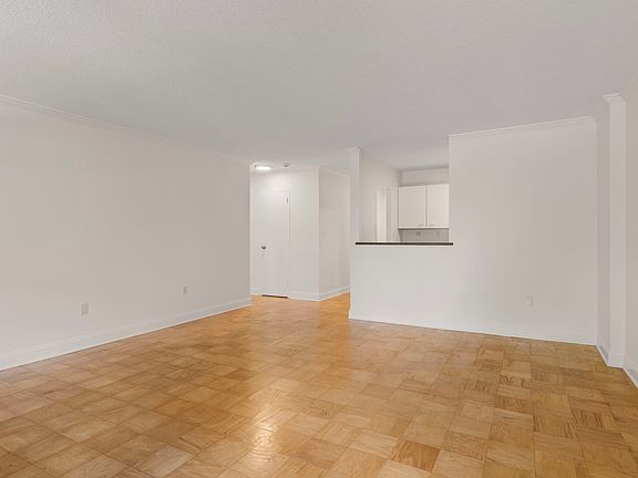 Dining area toward kitchen & hallway to bed and bath.