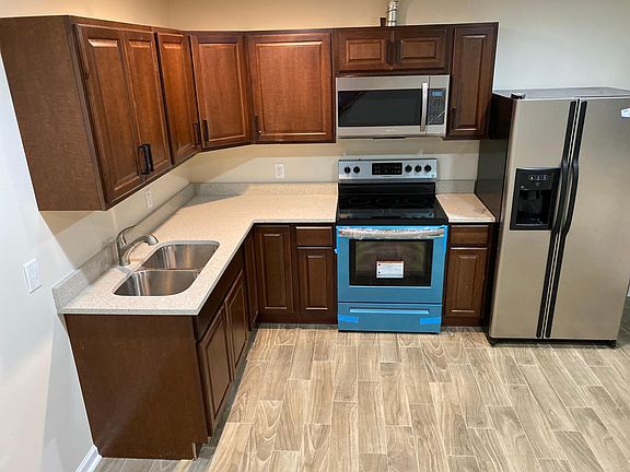Brand new kitchen with a brand new electric stove and a refrigerator