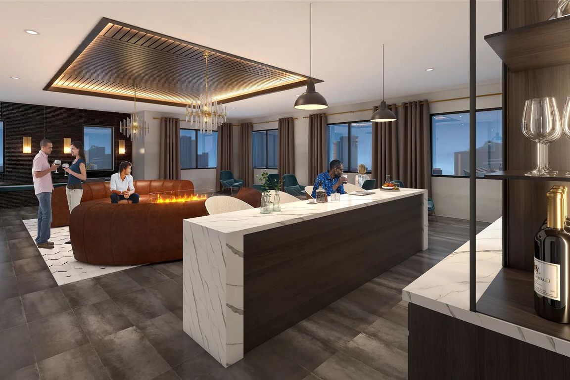 8th-floor sky lounge with gathering space, bar area, and sweeping views at Modera Encore apartments in Tampa.