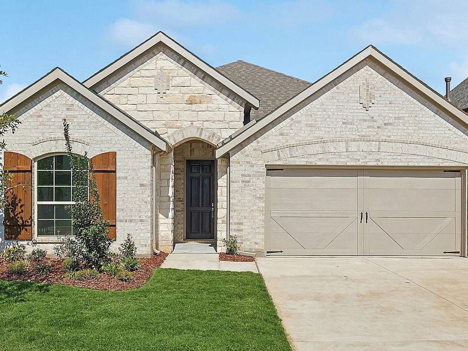 Exquisite stone facade, arched entryway, Stream Waters. Meticulous landscaping enhances curb appeal.