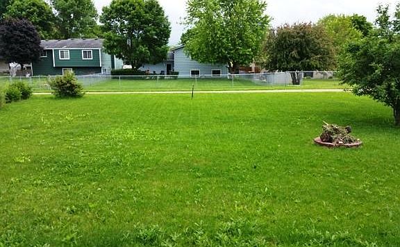 Large Backyard with firepit and walking trail access.