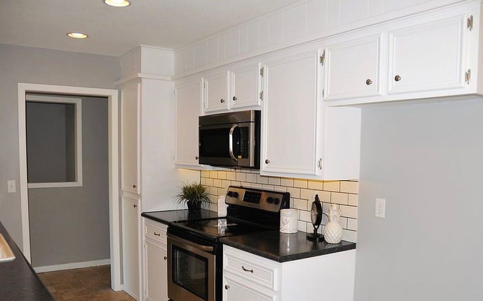 Kitchen has black Fridge 