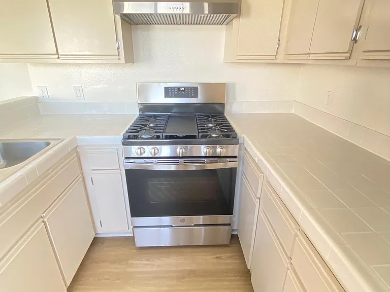 Kitchen with updated stainless steel appliances.