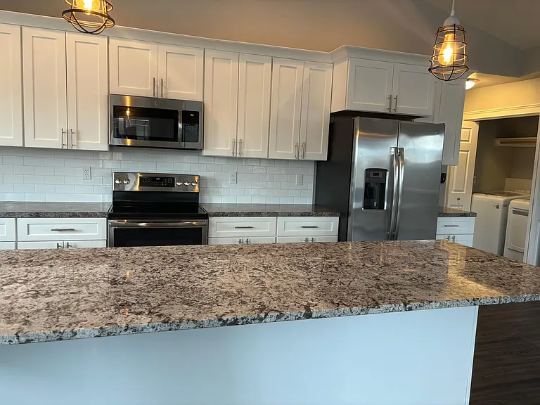 Stainless steel appliances with Fridge, Stove/Oven Microwave and Dishwasher.