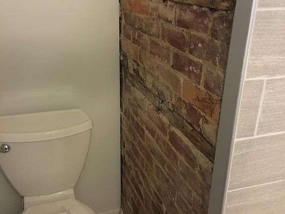 Exposed brick in the recently renovated bathroom