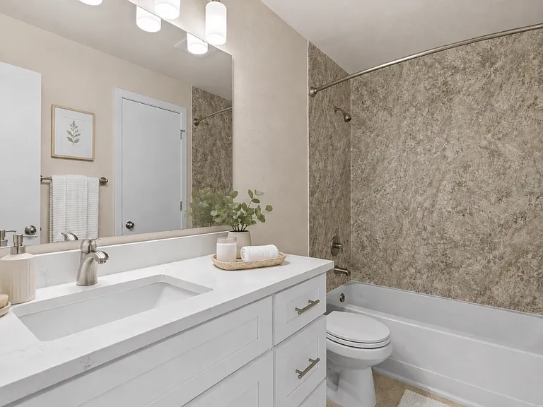 A bright, refreshed bathroom with modern finishes, generous vanity storage, and a full bathtub and shower combination. A bright, refreshed bathroom with modern finishes, generous vanity storage, and a full bathtub and shower combination.