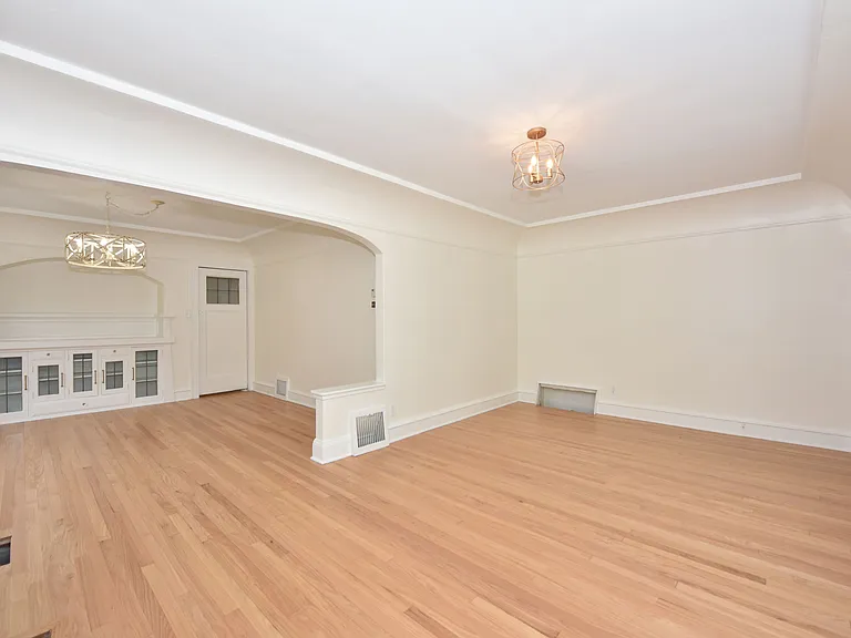 Living space looking south, front door entry is in the back right of this photo