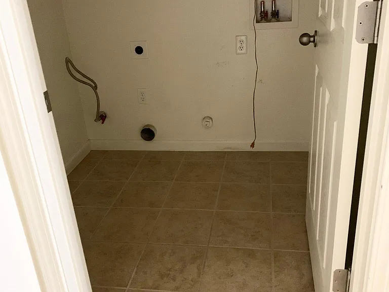 Separate laundry room with shelf