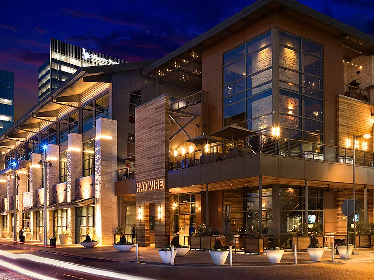 Enjoy rooftop dining at Haywire, located near Metro West at 8055 Windrose Ave, TX, offering great food and stunning views in a lively atmosphere.