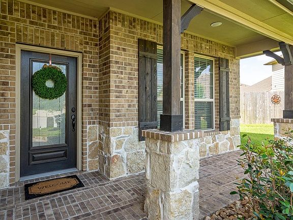 Darling front porch with stone and wood beam accents.