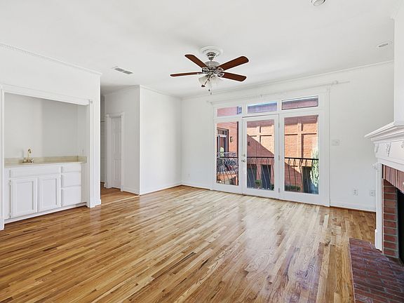 Main living area with balcony, fireplace, wet bar, dining area, kitchen and convenient half bath