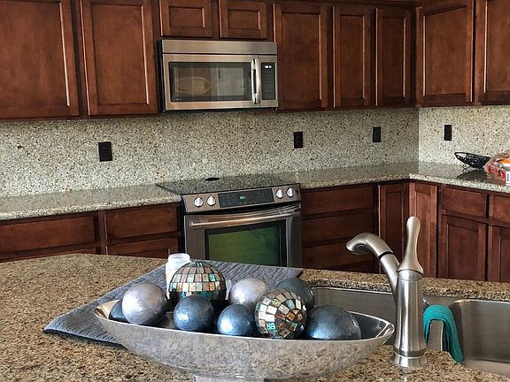 Large island with seating. Well stocked gourmet kitchen with stainless appliances