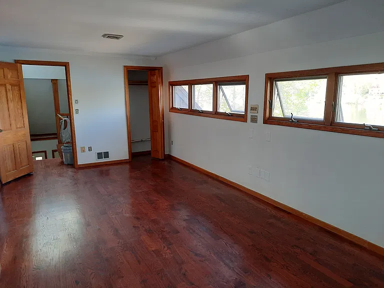 view of living room from the other side, note the closet and door