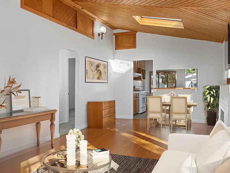 Living area with furnished renderings.