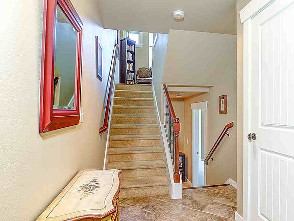 You're welcomed by a formal entry foyer. Stairs up to main living level, and down to lower bedrooms, full-size laundry room, full bathroom, extra storage, and backyard patio.