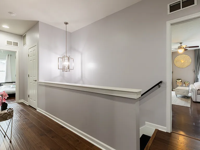 Landing at top of stairway; Entrance to primary bedroom.