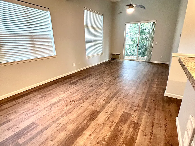 Living room with ceiling fan and balcony