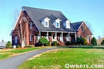 Great front porch and asphalt drive