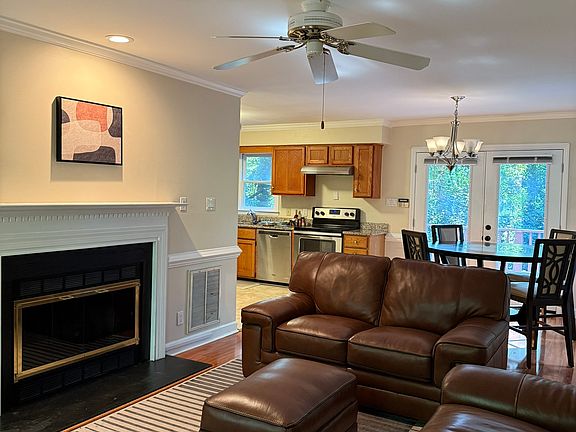 Open floorplan with fire place in the living room and access to backyard deck from the dining area