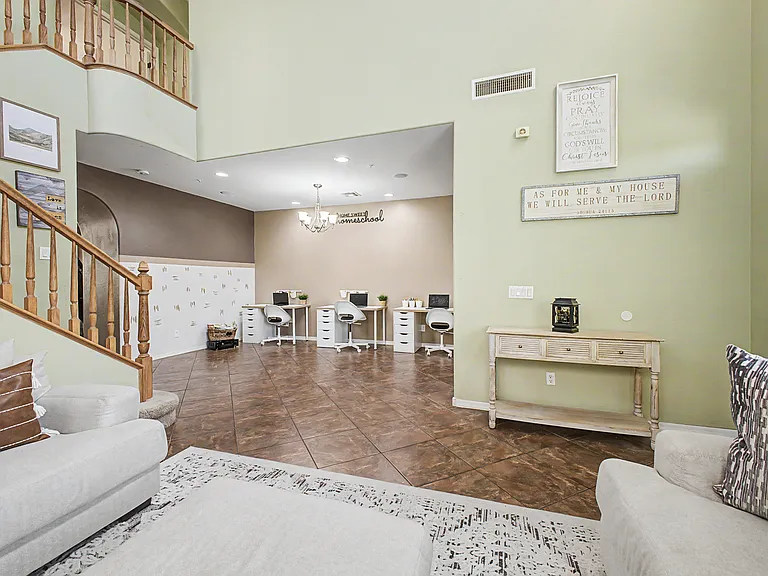 The entry area is currently set up as a welcoming living room and dedicated homeschool/workspace. If you choose to rent the home unfurnished, this versatile space can easily be transformed into a formal living and dining area to suit your needs.