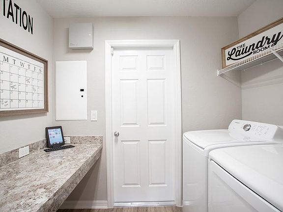 Laundry area with convenient drop-zone for additional organization and storage - New home for sale i