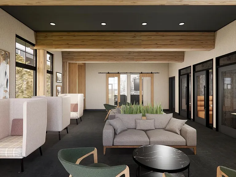 The coworking lounge at Modera Bridle Trails blends open workspace with privacy pods designed for focus and flexibility.