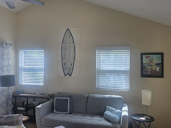 Living room has vaulted ceiling w/ceiling fan