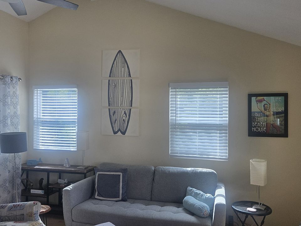 Living room has vaulted ceiling w/ceiling fan