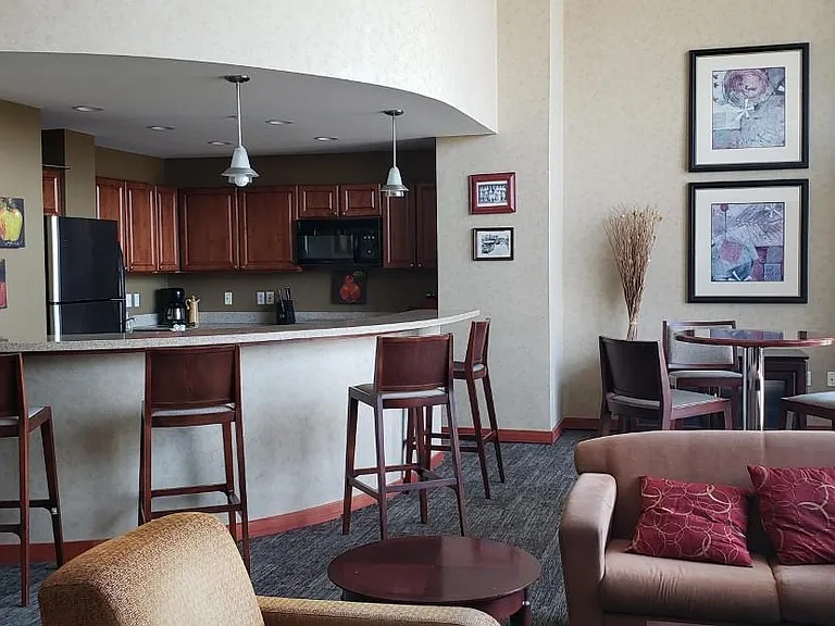 Partyroom has full kitchen and a good amount of seating for an event.