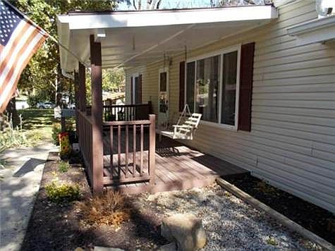 NICE COVERED FRONT PORCH WITH SWING