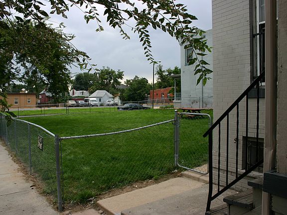 extra large fence side yard shared with other units with rasberry bushes