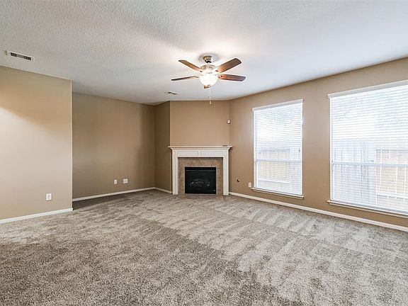 Enjoy this spacious and relaxing family room with a cozy fireplace.