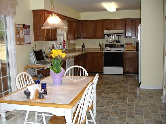 Kitchen with breakfast area leads to deck
