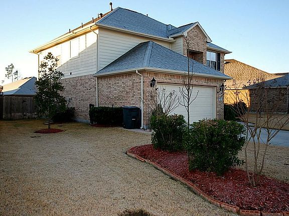 A view of the other side of the front of the home show casing special care to the yard.