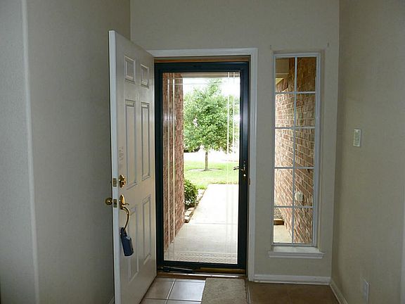 Beautiful entry with glass storm door.