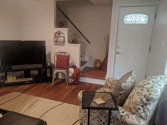 Living room view of entry and staircase