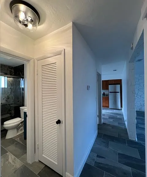 View from the bedrooms into the bathroom, kitchen & living room on the left.