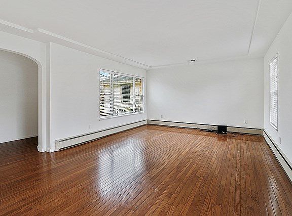 Light, bright and airy, the beautiful living room sports original hardwood floors and is freshly pai