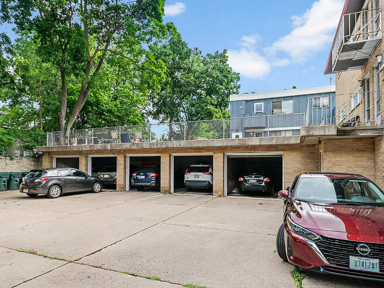 Garage bays with deck on top. Notices little patios outside the units.