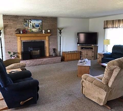 bright cheery living room offers plenty of space for big gatherings of friends and family...