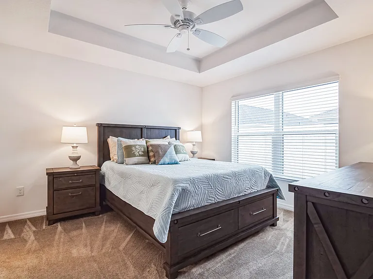 Master Bedroom with Vaulted Ceilings, Backyard View, and Ceiling Fan.