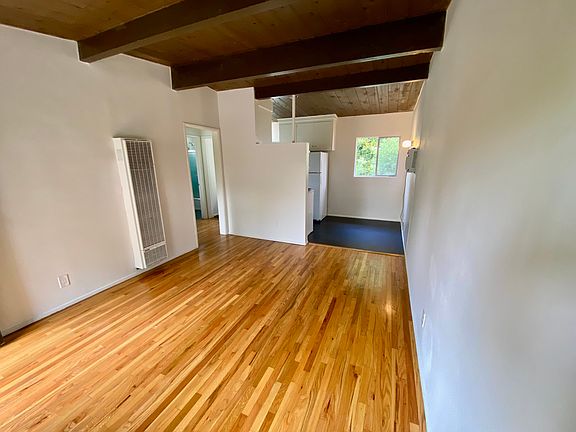 View from the front door into the living room and in-kitchen dining area