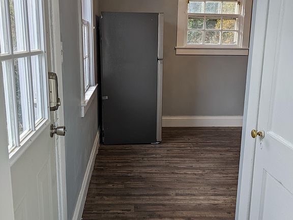 Door to left is side entrance/exit. Door to right is down to the basement. Looking into kitchen standing in living room